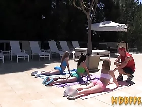 Teen girls with impressive flexibility take turns giving a wild ride to their instructor at a crazy party